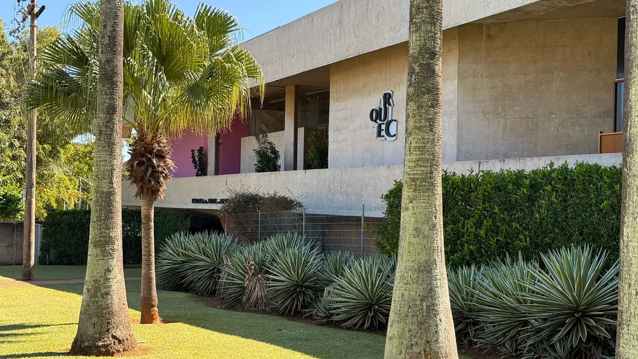 Fachada moderna da Arquitec cercada por palmeiras e paisagismo